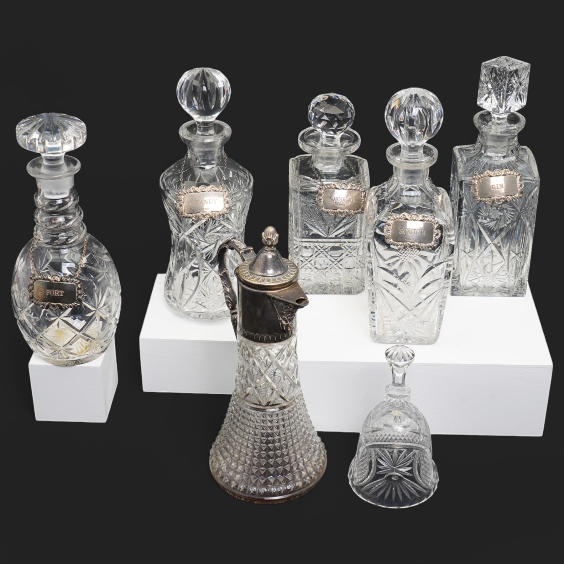 Six crystal decanters, four with silver labels and one with silver plated mount, and one etched glass dinner bell, tallest H30cm 