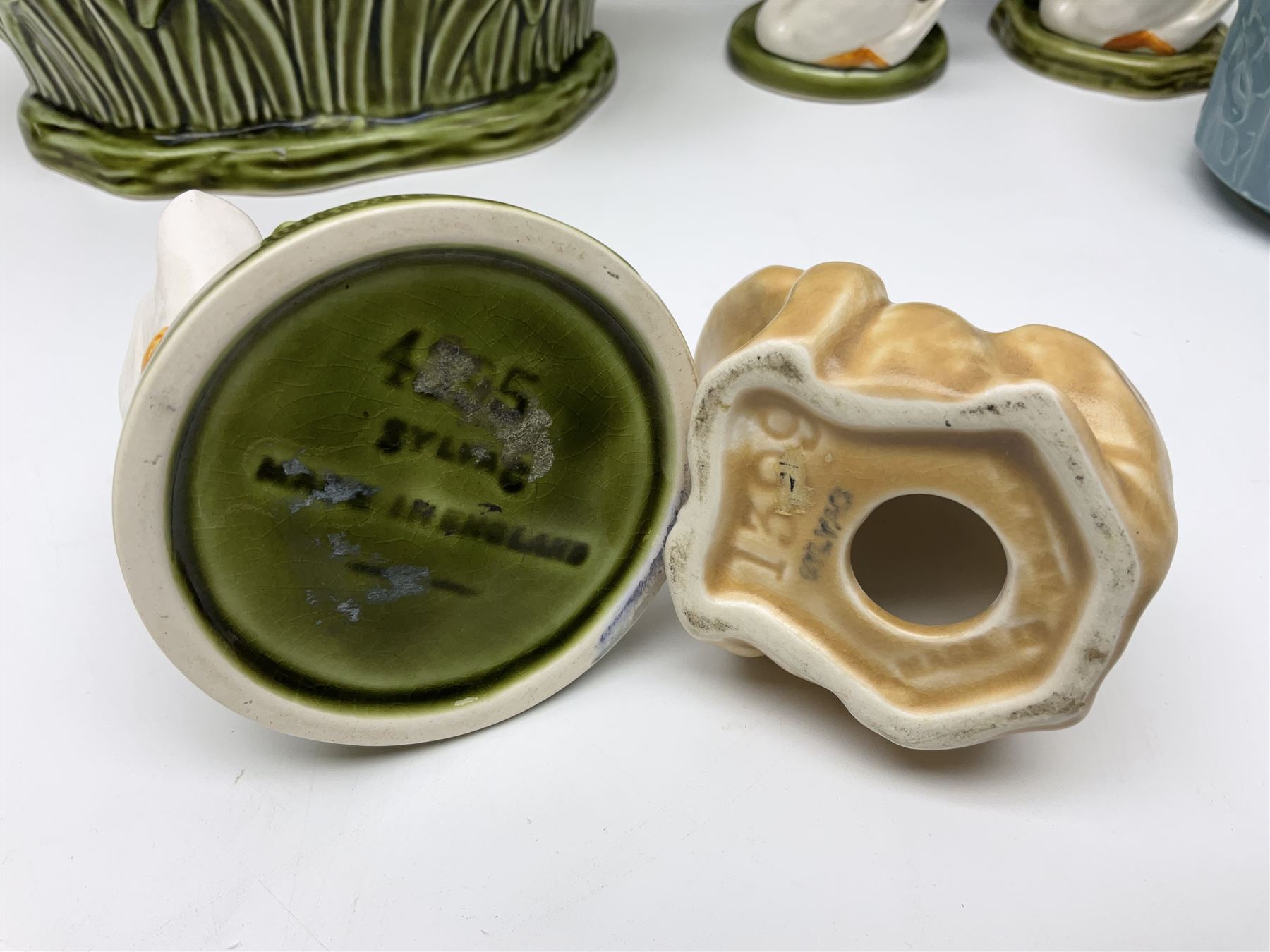 Sylvac budgieregar wall pocket, together with other Sylvac cermics including swan vases, blue tit vase and a frog figure etc, all with printed or impressed marks beneath, and a Poole Pottery cat figure, with printed mark beneath, wall pocket H22cm