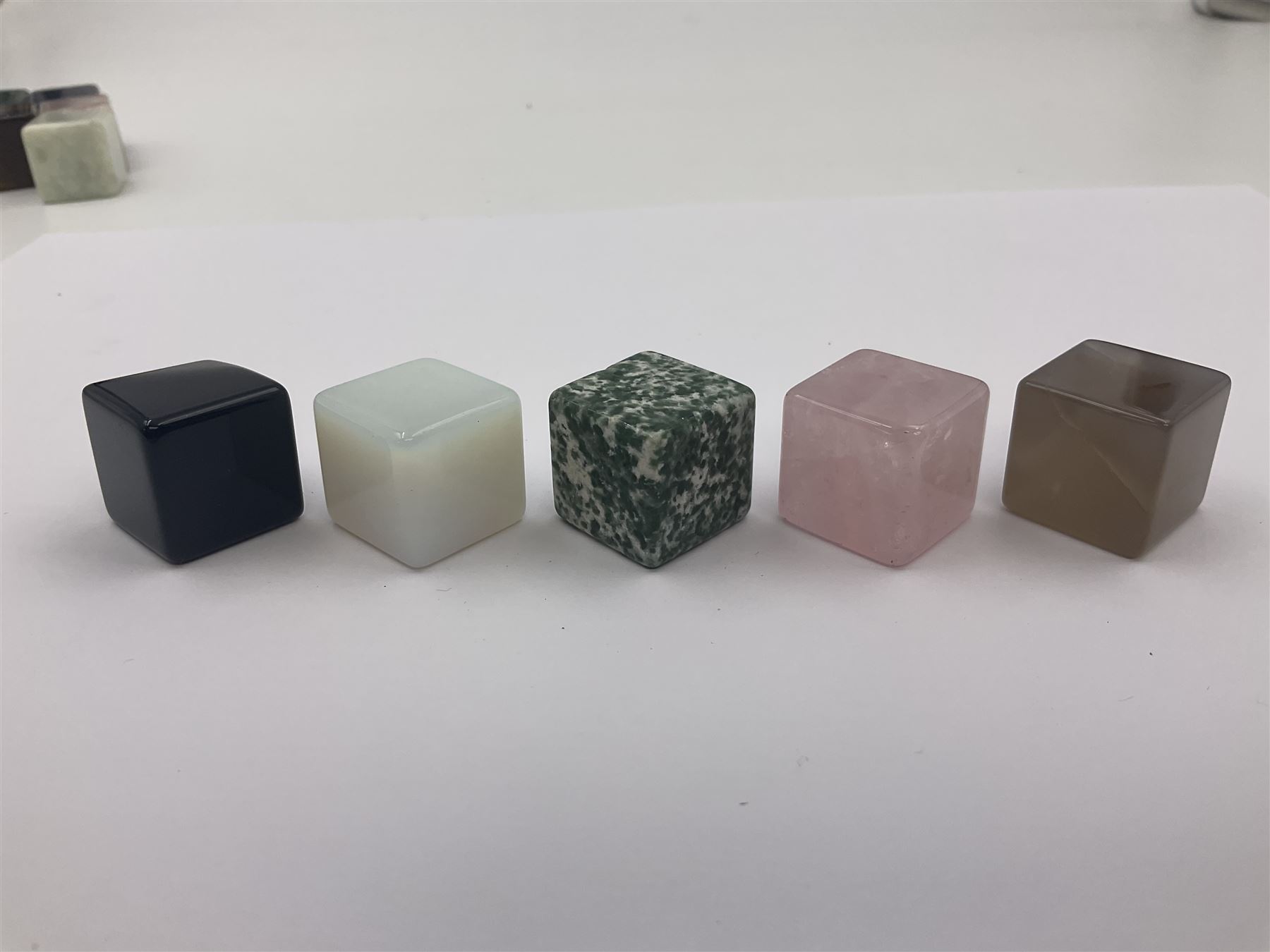Fifteen cube mineral specimens, each cut and polished to highlight natural formations, including tiger eye, black obsidian, green aventurine, rose quartz, opalite, rhodonite etc, H2cm 