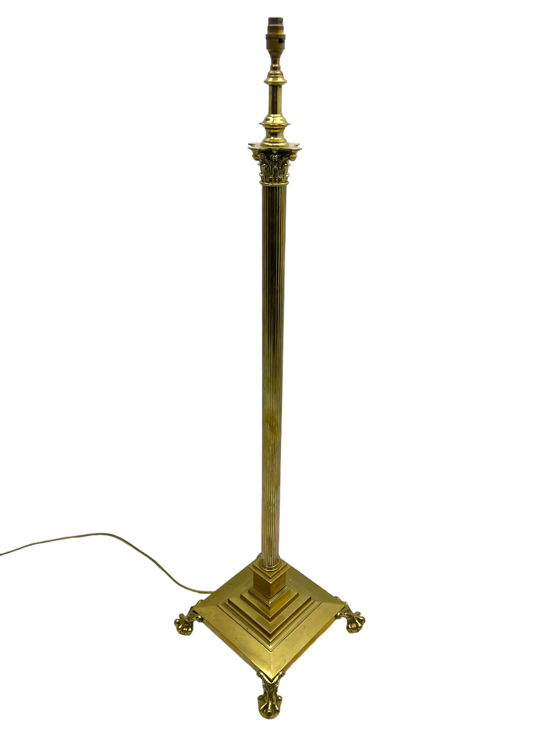 Late 20th century brass telescopic standard lamp in the form of a Corinthian column, Corinthian acanthus leaf capital over reeded shaft, stepped and moulded square base with four extending ball and claw feet