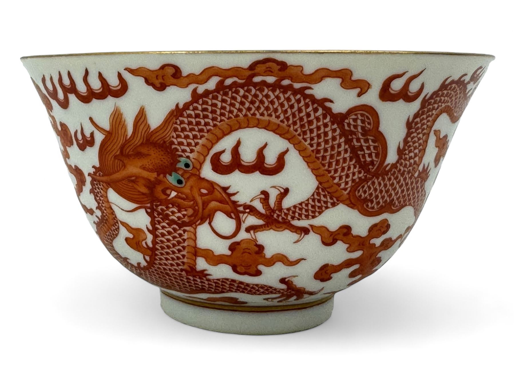 Chinese porcelain iron red tea bowl, the exterior painted with two five claw dragons chasing the flaming pearl, amidst clouds, red Quinlong seal mark beneath, D10.5cm x H6.5cm