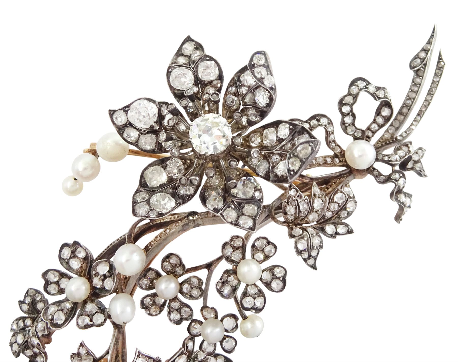 19th century gold and silver diamond and pearl en tremblant detachable brooch, the flower tremblant with a principal old cut diamond of approx 1.90 carat, the petals and stamen set with old cut and rose cut diamonds, total diamond weight approx 9.10 carat, to a foliate spray set set with further rose cut diamond and white / pink / cream pearls and ribbon tie
