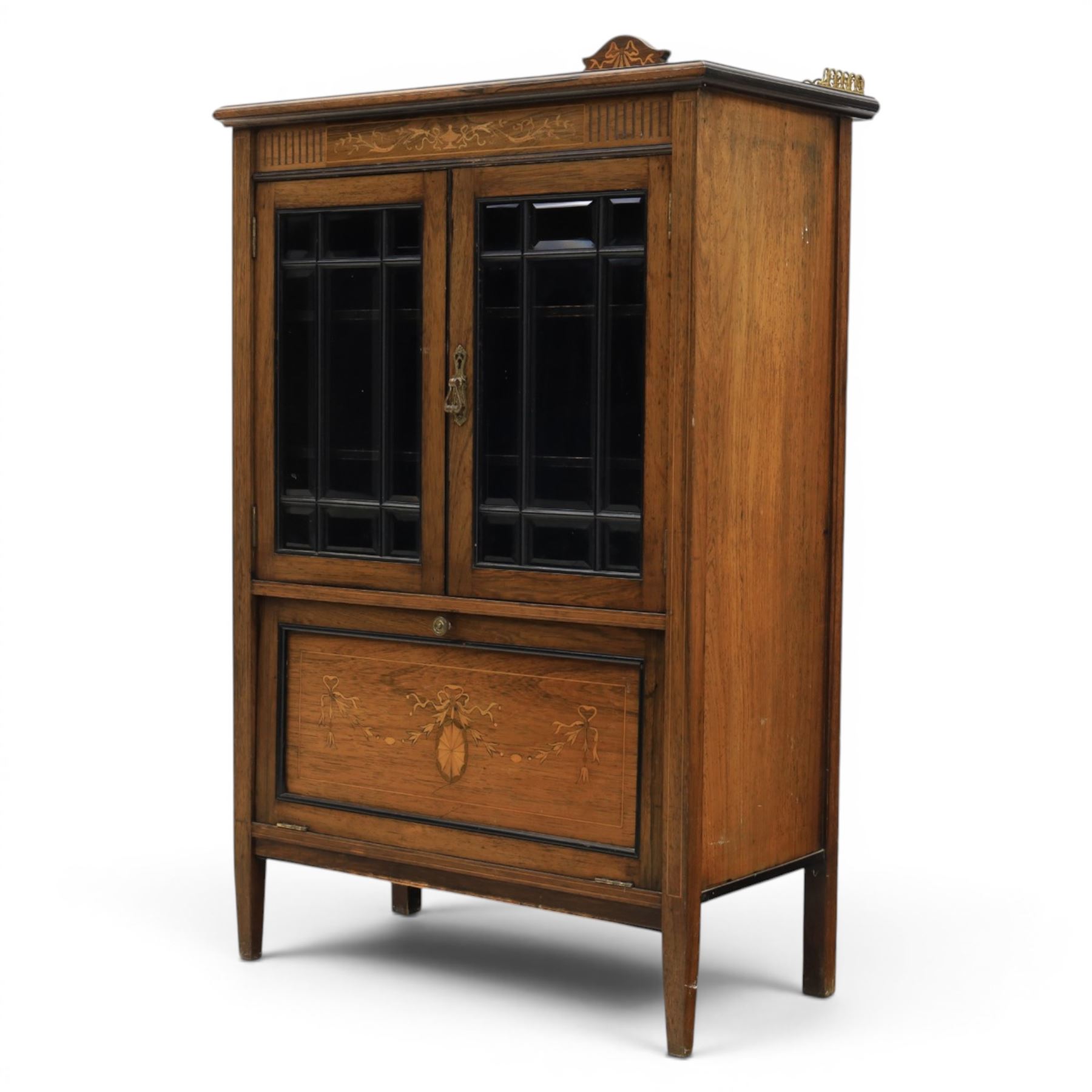 Druce & Co - Edwardian inlaid cabinet, galleried topwith inlay and brass galleried top, inlaid frieze above twin bevel glazed doors revealing a shelved interior, the lower section with fall front cupboard