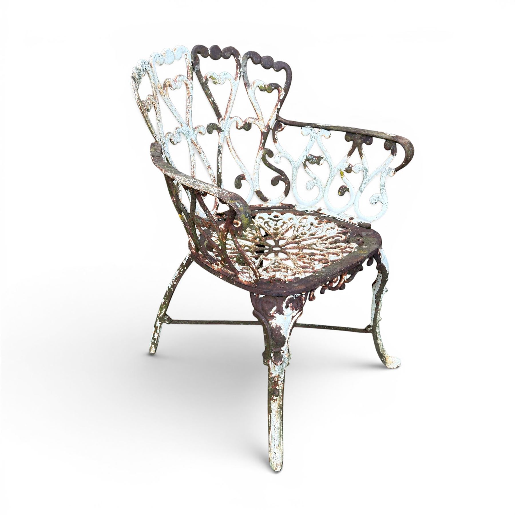 Pair of late 19th century painted cast iron garden chairs, open scroll and heart backs, ornate circular seat, raised on cabriole legs with X stretcher