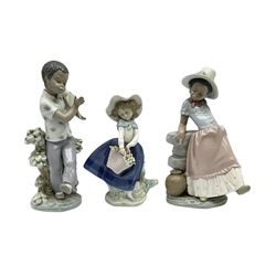 Pair of Lladro figures designed by Jose Roig, Bongo Beat no. 5157 and A Step in Time no. 5158 and a Lladro figure of a girl with a basket of flowers.
