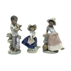 Pair of Lladro figures designed by Jose Roig, Bongo Beat no. 5157 and A Step in Time no. 5158 and a Lladro figure of a girl with a basket of flowers.

