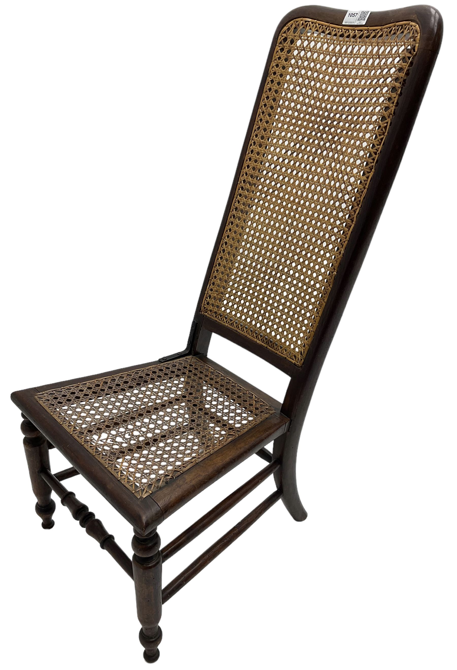 Early 19th century stained beech and mahogany child's correction chair, cane seat and back raised on turned supports united by stretchers