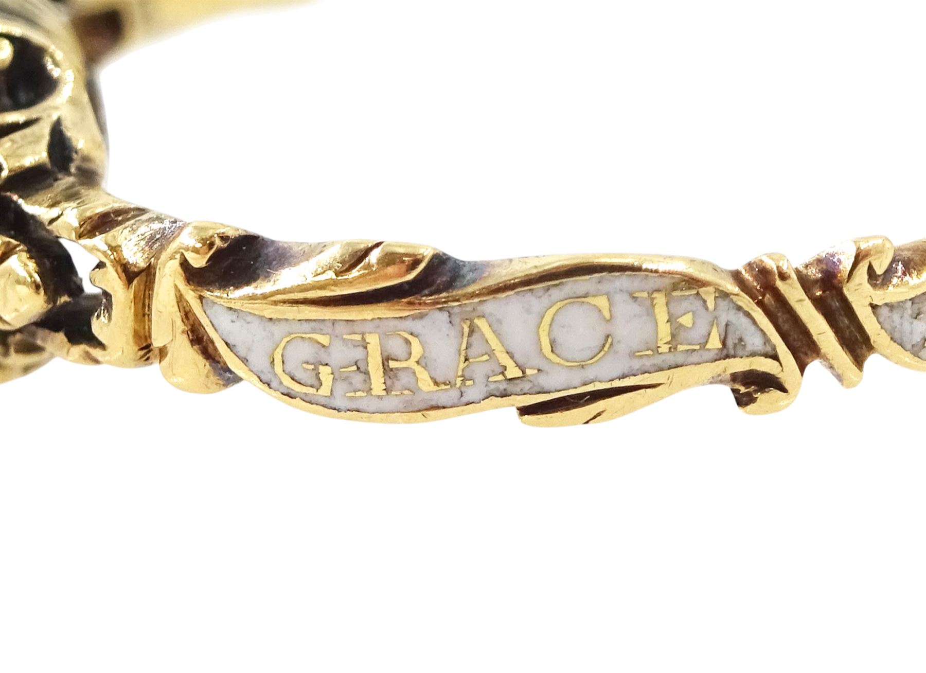 George II 18ct gold amethyst and enamel mourning ring, single cushion cut amethyst, with foiled and glazed back, to pierced fleur-de-lis shoulders, the white enamelled shank engraved Grace Hutchinson OB: 13 Dec: 1756