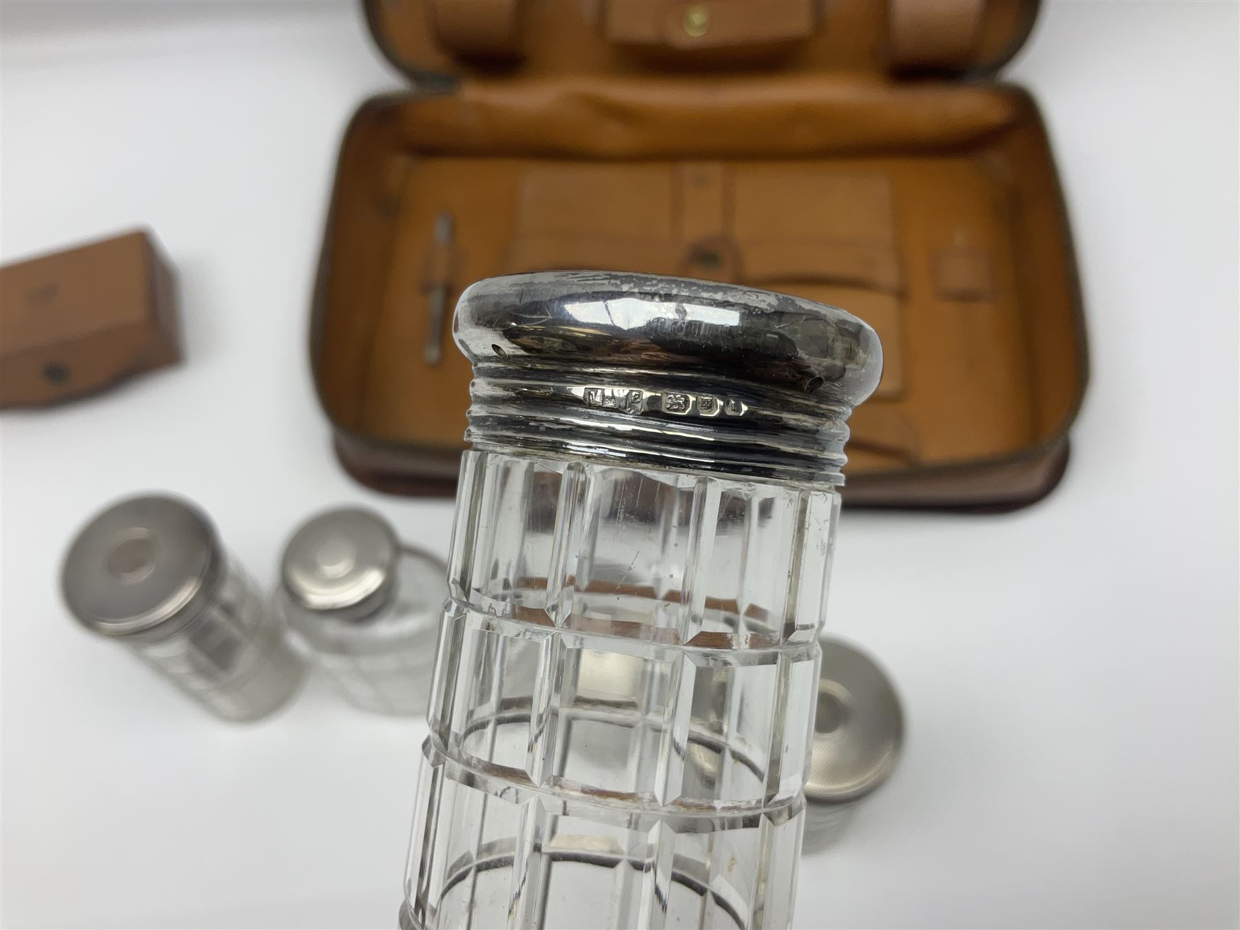 Mappin & Webb leather cased campaign gentleman's vanity set, the tan leather case opening to reveal fitted interior with five engine turned silver capped glass vanity bottles, hallmarked Mappin & Webb, London 1944, brushes, mirror etc, monogram DPK to the top of the case