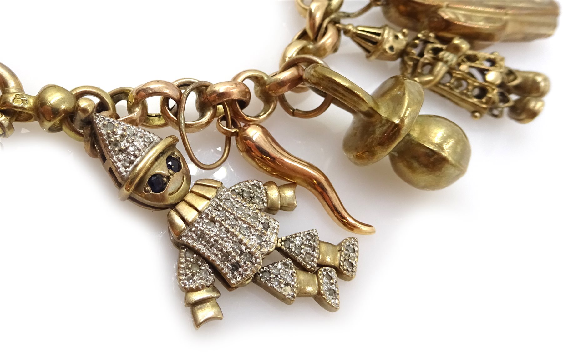 Gold belcher link bracelet with fourteen gold charms including ragdoll, clown, horse and money box, all 9ct hallmarked, tested or stamped