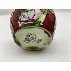 Three Minton Secessionist vases, with tube-lined stylised flower decoration, two upon a red ground and third upon a purple ground, all with printed mark to base 'Minton Ltd, No. 33', H13cm