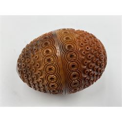 Three 19th century coquilla nut pomanders or flea catchers, two of egg shaped form and the third of barrel from with carved and pierced decoration and screw threaded join, largest H8cm