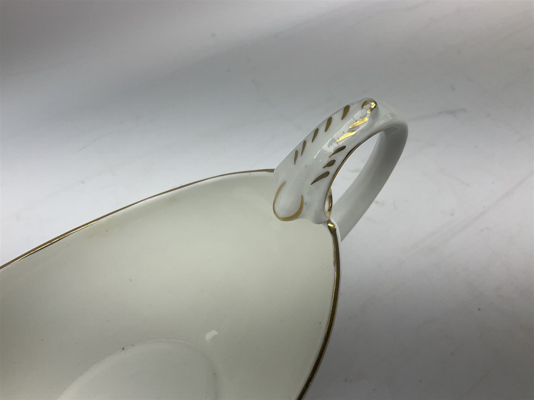 Coalport Revelry pattern tea and dinner wares, comprising nine dinner plates, four salad plates, eleven side plates, sauce boat and stand, ten teacups and ten saucers, and preserve pot and cover, together with a Coalport plate of shaped form decorated with pink roses, and a Royal Crown Derby Royal Antoinette pattern trio