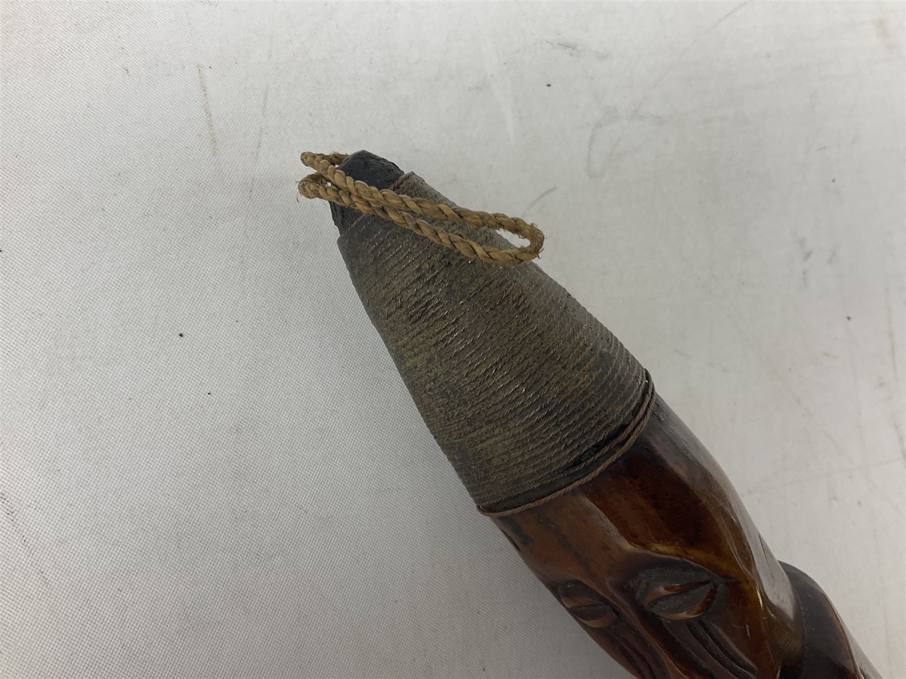 Tribal Art - an African axe, possibly Yoruba, the bone shaft carved as two cord bound stylised figures with iron fan-shaped blade, L35cm overall; and 19th century harpoon or spear head of square section with two long fixing arms on cut-down ash shaft L57cm (2)