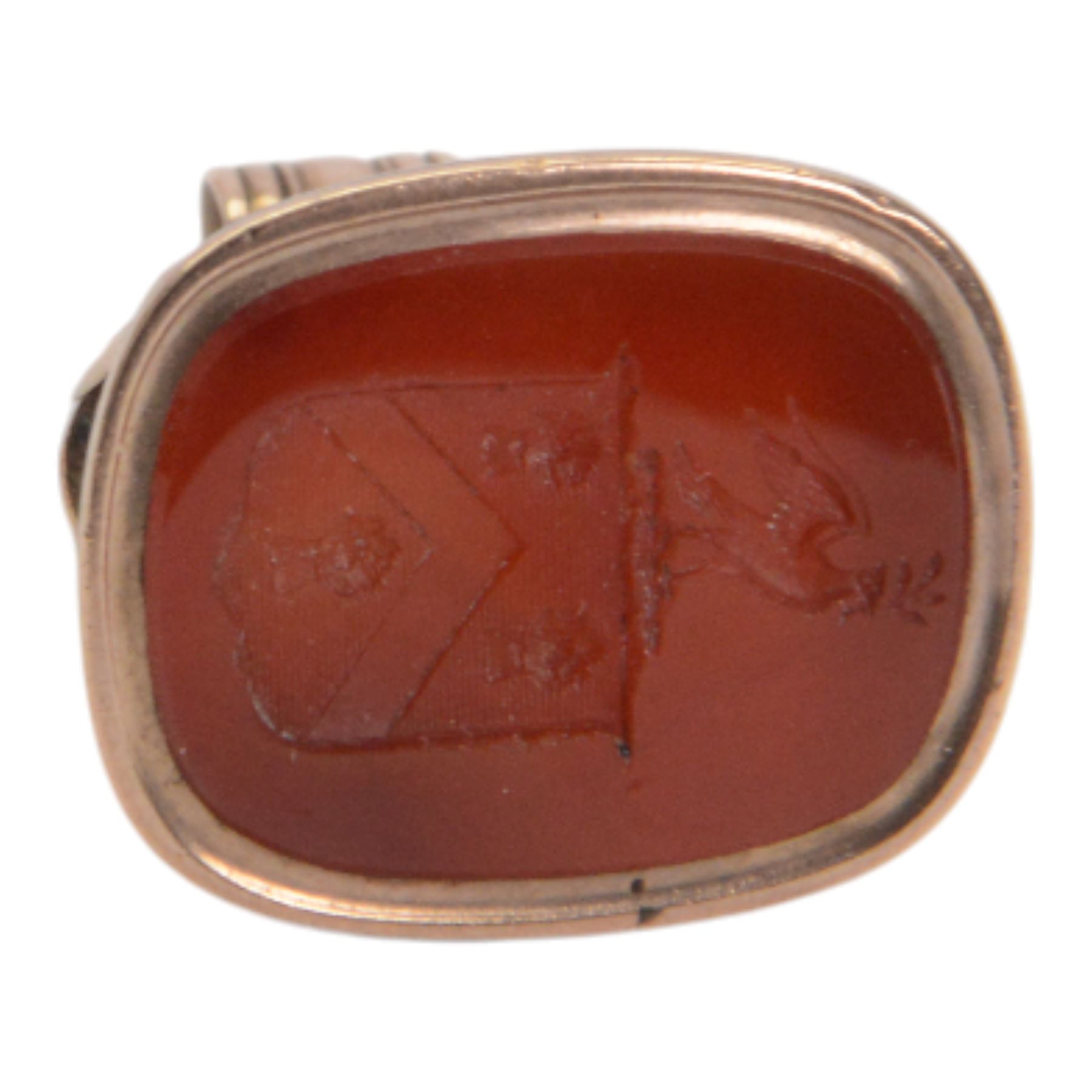 Late 18th/early 19th century 9ct gold fob seal, the carnelian matrix engraved with coat of arms, depicting a shield surmounted by a bird with foliage within its beak, within a scrolling mount detailed with a bird drinking from a chalice, H3.5cm 

Provenance: By family descent from the Chichesters of Arlington Court, Devon; from the collection of Andrew Chichester Everitt.
