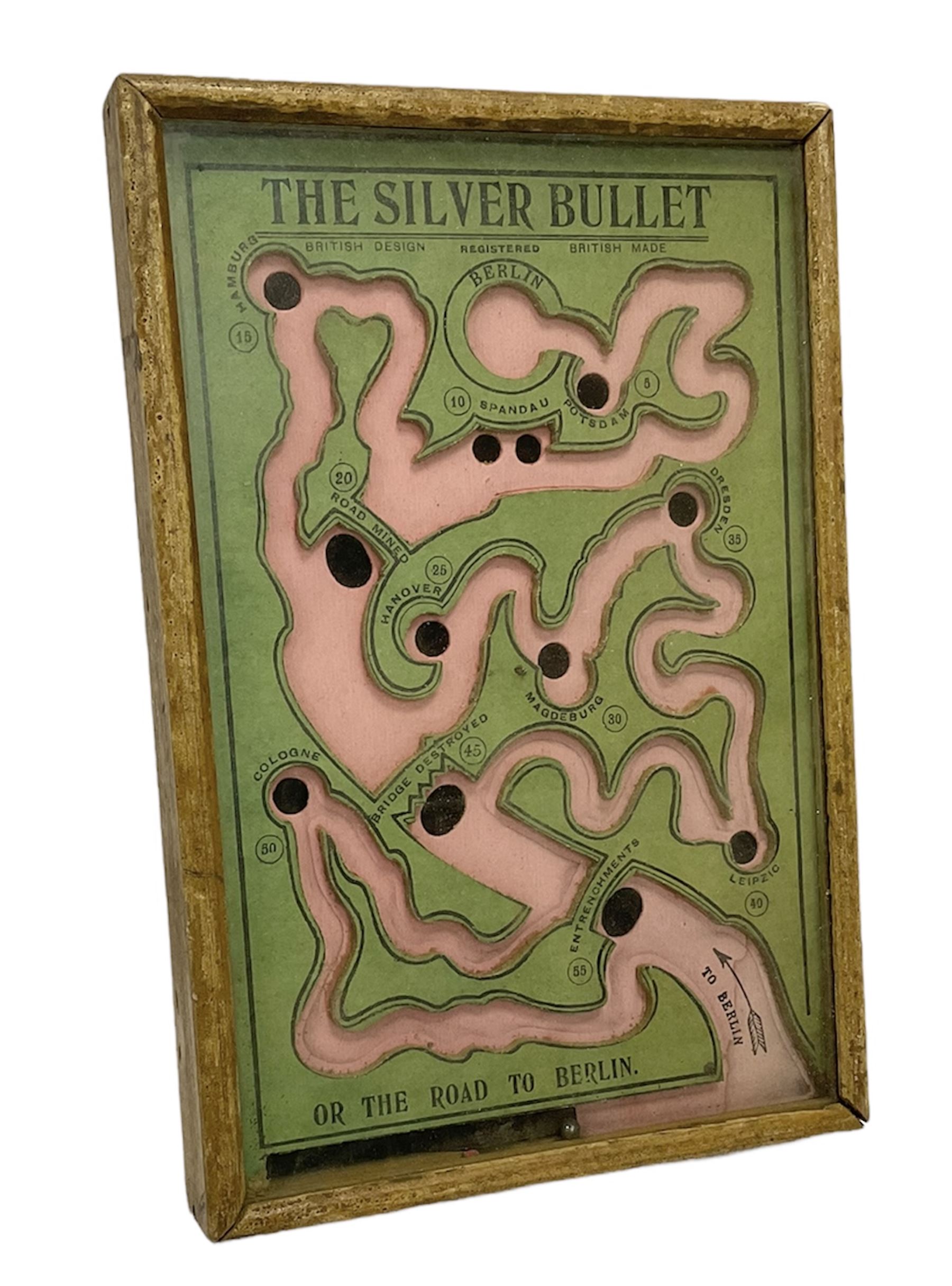 WWI 'The Silver Bullet or the Road to Berlin' ball bearing puzzle game, the stylised printed card map marked with various German towns and hazards on the allied advance to Berlin passing through towns and cities such as Hamburg and Dresden, manufactured by R. Farmer and Son circa 1916, with instructions label verso, in glazed frame
