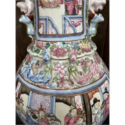 Large pair of 19th century Cantonese famille rose vases, each painted with various courtly scenes, including a display of warriors fighting on horseback before an official and his attendants, double Buddhist lion handles and applied at the shoulders with chilong, the lower band painted with Greek key motif, H58cm (2)