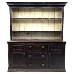 Early 19th century scumbled pine dresser, the projecting cornice over two heights plate rack with moulded frame, the base with reeded canted corners fitted with three drawers and two panelled cupboards, panelled sides, moulded skirt base