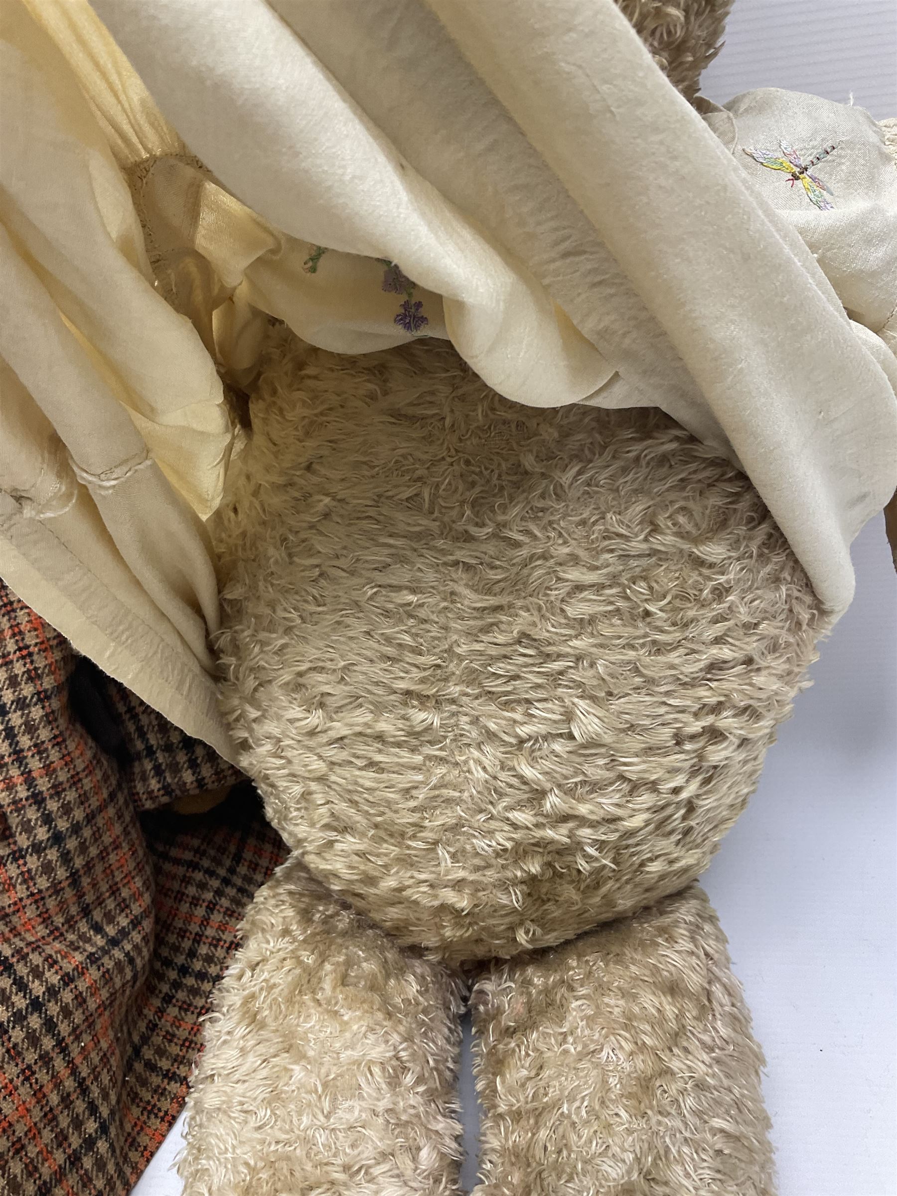 Two early 20th century straw filled jointed teddy bears, first example wearing a tweed jacket bearing Geoffrey Saville label, with leather padded paws and ears, horizontally stitched nose and humpback; second example with applied eyes, vertically stitched nose and faux leather paw pads, both with growler mechanisms, tallest H74cm 