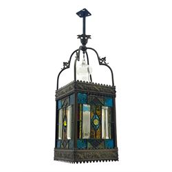 20th century Gothic design stained glass and brass hall lantern, with ornately decorated frieze and apron, with geometric coloured glass panels and eight rectangular bevelled glass panels, with bell shade, wired for electricity 