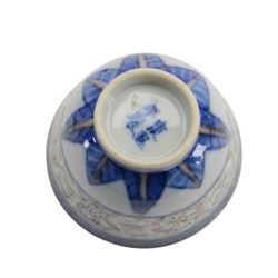 Chinese late Qing Dynasty Guangxu period rice grain detailed teabowl and saucer, each decorated in underglaze blue with flowers and foliate borders, and further detailed with iron red and pale green band of flower heads, and scrolling bands, teabowl with apocryphal Kangxi mark beneath and saucer with apocryphal Qianlong mark beneath, teabowl H5cm, saucer D10cm
