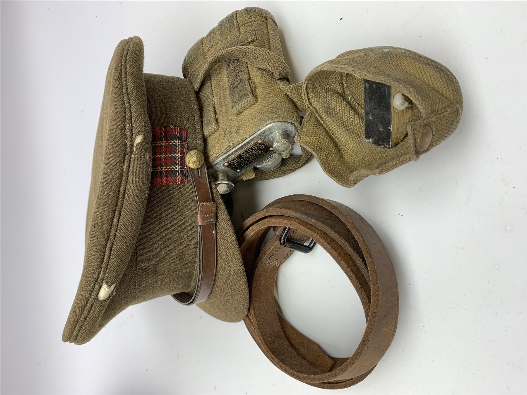 Scots Guards - two officer's peaked caps with chin strap and side buttons, one with badge, and blue dress peaked cap marked HEB for Harold Ellett-Brown; two Artist Rifles and one West Yorkshire cap badges and two Scots Guards shoulder flashes; officer's brown leather Sam Brown belt with shoulder brace strap and revolver holster; officer's Orilux trench torch etc