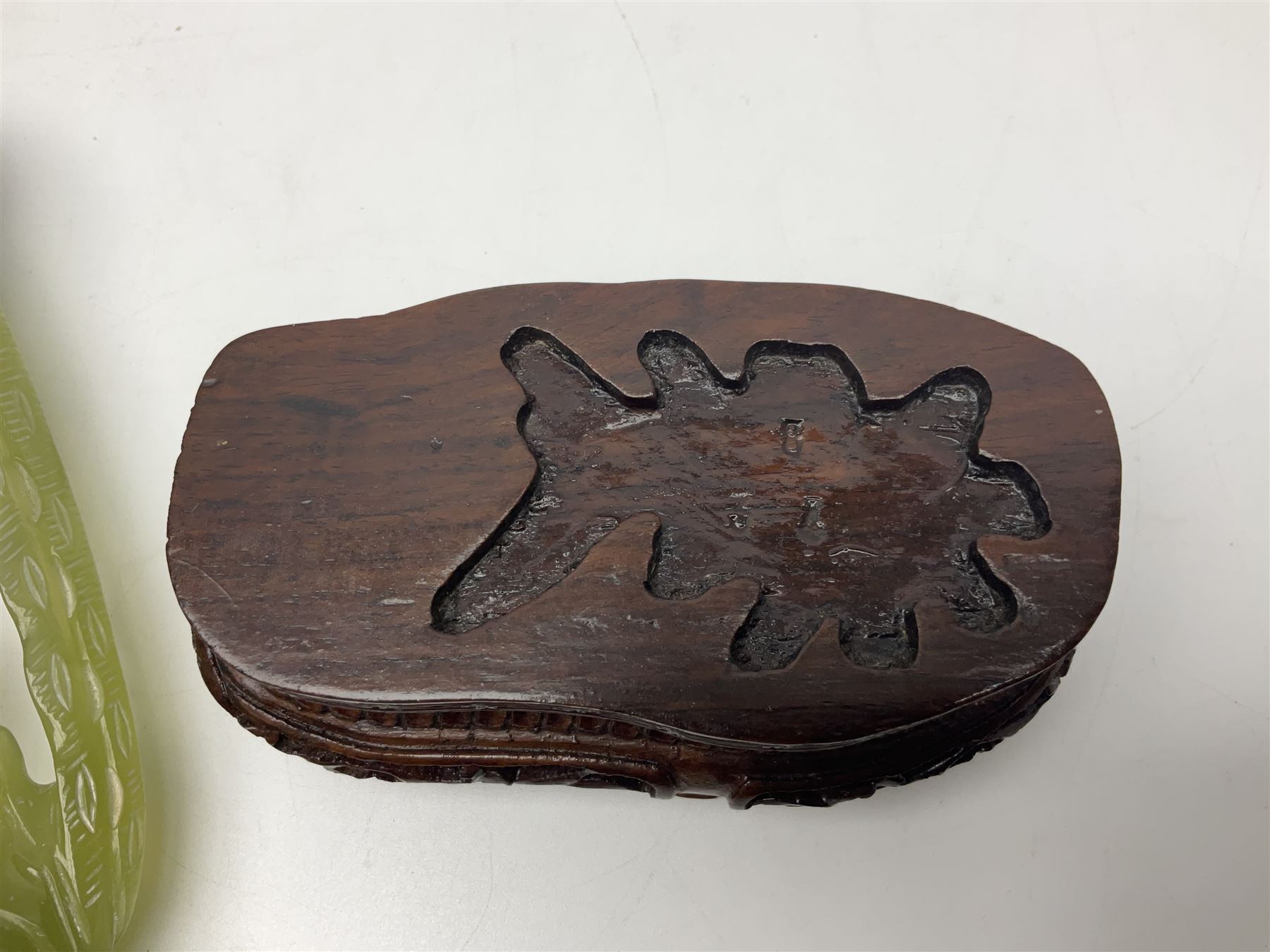 Carved jade figure of a phoenix perched on a flowering branch, upon a wooden stand, with original box, H27cm