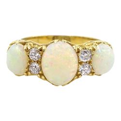 Early 20th century opal and diamond ring, three oval opals with four old cut diamonds set between, stamped 18ct