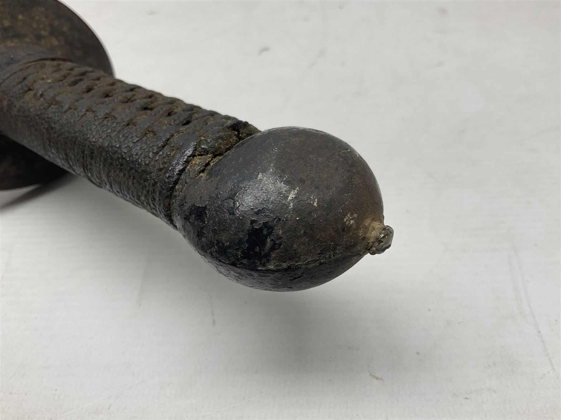 Chinese Boxer Rebellion Period Sword, 69.5cm heavy curved single edge blade with single narrow fuller, plain iron dished circular guard, iron pommel and ferrule with plaited cord bound grip; in skin covered wooden scabbard with iron chape and long suspension mount L95cm overall