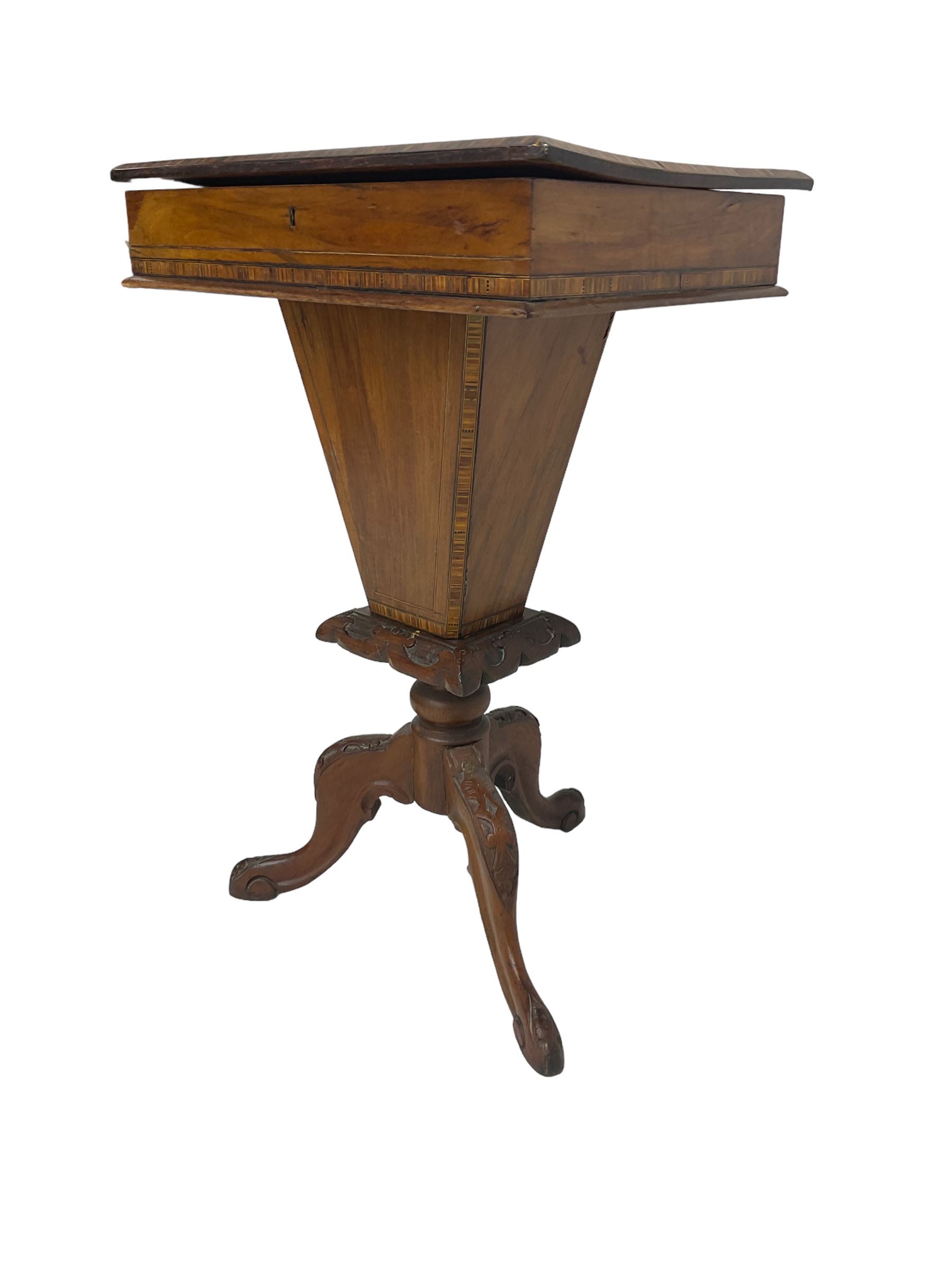 Victorian walnut work table, the rectangular hinged top inlaid with a chessboard design, canted edge with alternating ebony and satinwood inlays, concealing fitted interior, banded and strung frieze over tapering column well, collar carved with foliate decoration, on a cabriole tripod base
