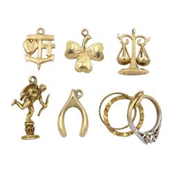 Six 9ct gold pendant/charms including cupid, three leaf clover, wishbone, Libra and wedding bands 