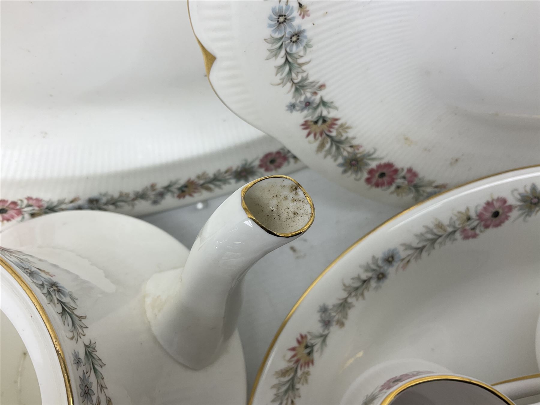 Royal Albert Paragon tea and dinner service for twelve decorated in the Belinda pattern, comprising fourteen saucers, twelve teacups, thirteen side plates, teapot, sauce boat and stand, salt and pepper shakers, two jugs, sucrier, twelve dinner plates, twelve smaller plates, two lidded tureens, twelve bowls, twelve smaller bowls, cake plate, oval plate and oval dish (100)