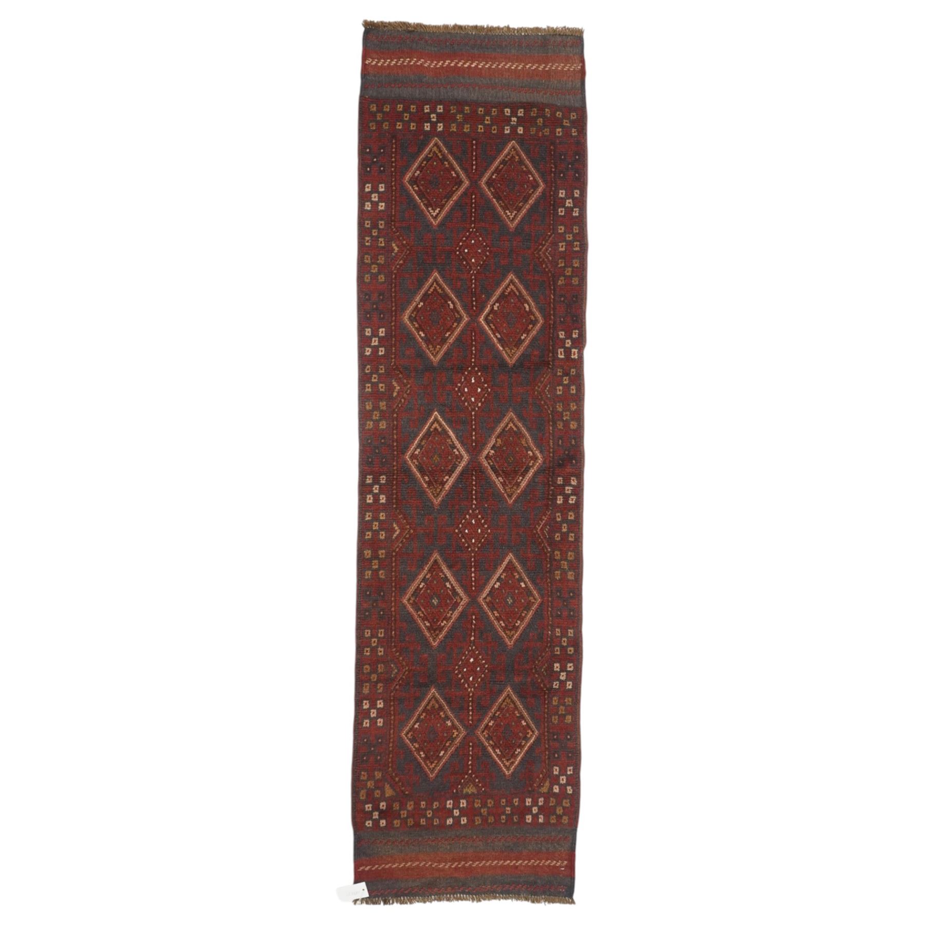 Afghan Meshwani runner, hand-knotted wool pile, indigo ground decorated with a vertical series of angular diamond medallions in tones of madder red, dark blue, framed by geometric borders with flatwoven kilim ends with fringe