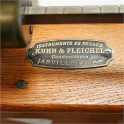 Early 20th century French oak height and balance scales, with graduated vertical rule, adjustable counterweight mechanism with brass and steel fittings, raised on a stepped rectangular oak base, bearing brass maker’s plaque, signed Kuhn & Fleichel, Jarville