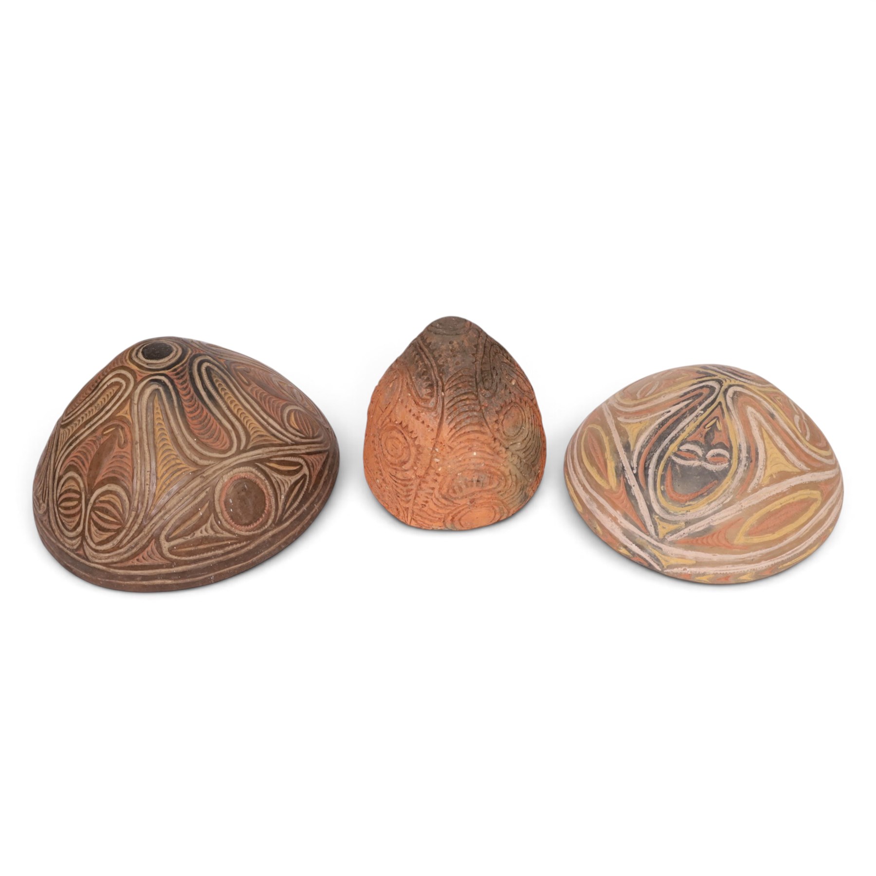 Two terracotta clay cooking pot, decorated with faces in neutral tones, together with three similar pots