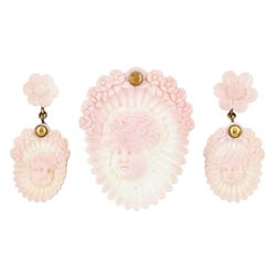 19th century gold conch shell pendant / brooch and matching earrings, each with carved bust shell of a cherub / child and flower head decoration, the earrings suspending a further flower head stud