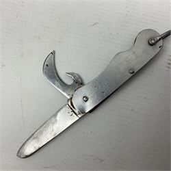 Fairburn Sykes style third pattern commando fighting knife, the 16cm double edged blade with central medial ridge, steel cross-piece marked with broad arrow and 'I', ribbed alloy grip L28cm overall (no scabbard); and Warriss Sheffield military pocket knife with two folding blades, marked with 'broad arrow 1953 and Oil The Joints' (2)