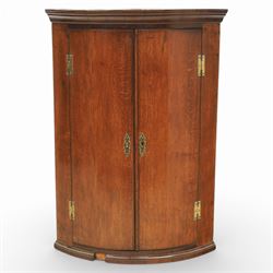 George III oak and mahogany wall hanging cylinder corner cupboard, moulded cavetto cornice over double cupboard enclosing three shelves
