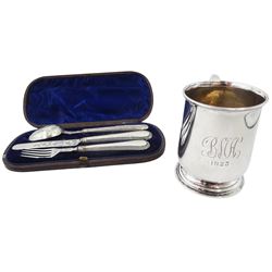 1920's silver christening mug, of plain form with engraved monogram and date to body and scroll handle, upon a circular stepped foot, hallmarked Walker & Hall, Birmingham 1925, H8.5cm, together with a Victorian silver three piece christening set, comprising knife, fork and spoon with beaded edge, hallmarked London, probably 1865, makers mark indistinct, contained within a fitted case with blue silk and velvet lined interior, approximate total silver weight 6.26 ozt (195 grams)