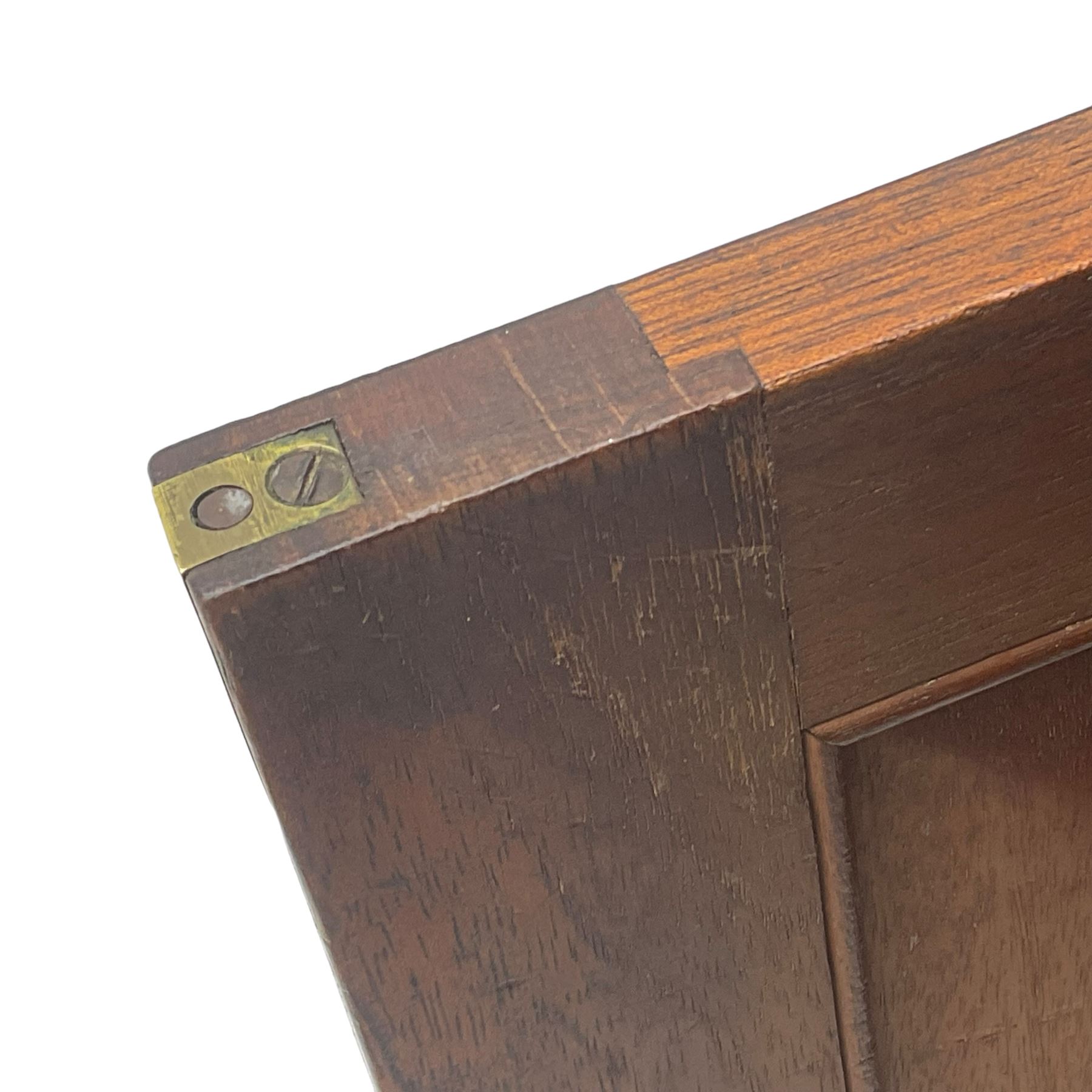 Early 19th century figured mahogany bureau bookcase, projecting splay moulded cornice over three adjustable shelves enclosed by two glazed doors, fall front revealing pigeonholes, cupboard and drawers, pull-out strays with scroll carved terminals, double cupboard with two panelled doors, on turned feet 