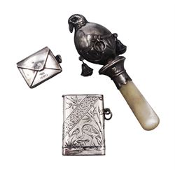 Victorian silver vesta case, with bright cut foliate and heron decoration, circular monogrammed panel and lift up cover, hallmarked Sampson Mordan & Co, London 1885, 1920's silver baby's rattle, in the form of a bird, with mother of pearl handle, hallmarked Adie & Lovekin Ltd, Birmingham 1921 and an early 20th century silver stamp holder, in the form of an envelope, with engraved initials to reverse, hallmarked Albert Ernest Jenkins, Chester 1910, approximate weighable silver 0.57 ozt (17.8 grams)