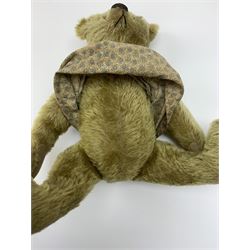 Early 20th century German Steiff teddy bear c1910 with wood wool filled humped back mohair body, swivel jointed head with black boot button eyes and horizontally stitched black nose and mouth, FF metal button to left ear, jointed elongated limbs with felt paw pads and black stitched claws H13
