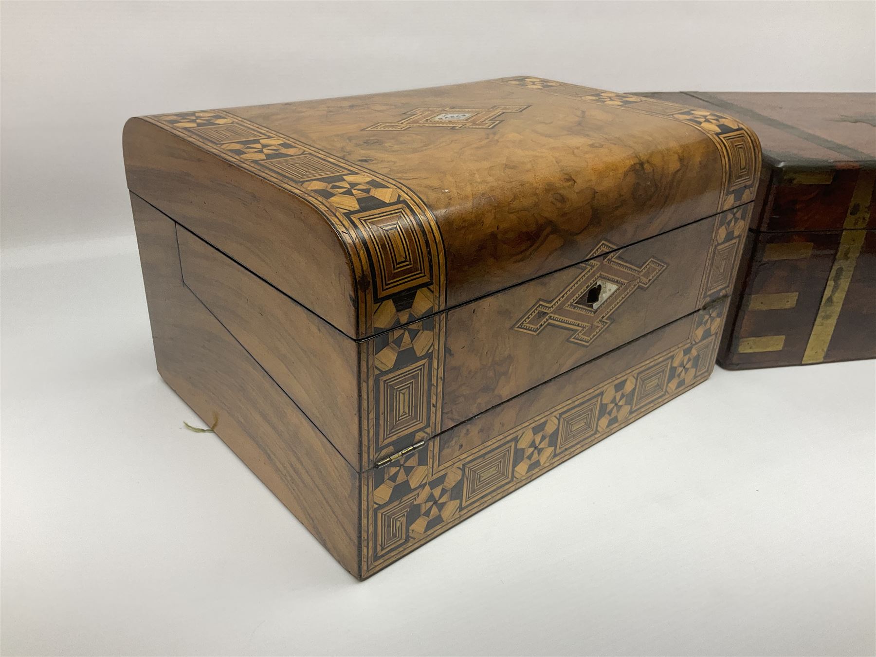 Victorian mahogany writing slope, the brass bound hinged cover opening to reveal tooled leather and gilt interior with two glass inkwells, together with a similar parquetry inlaid writing slope, with central mother of pearl inlay enrgraved 'Sarah', tallest H17cm 