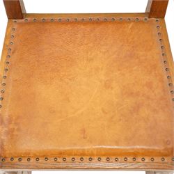 Mouseman - set of six (5+1) 1940s pre-war panel-back dining chairs, the raised backs with adzed panels, over seats upholstered in tan leather with studwork border, raised on octagonal turned baluster supports united by box stretcher, with carved mouse signature, by the workshop of Robert Thompson of Kilburn

Provenance: ordered directly from the Mouseman workshop in the 1940s before the outbreak of the war, the items were subsequently delivered after the end of war. 