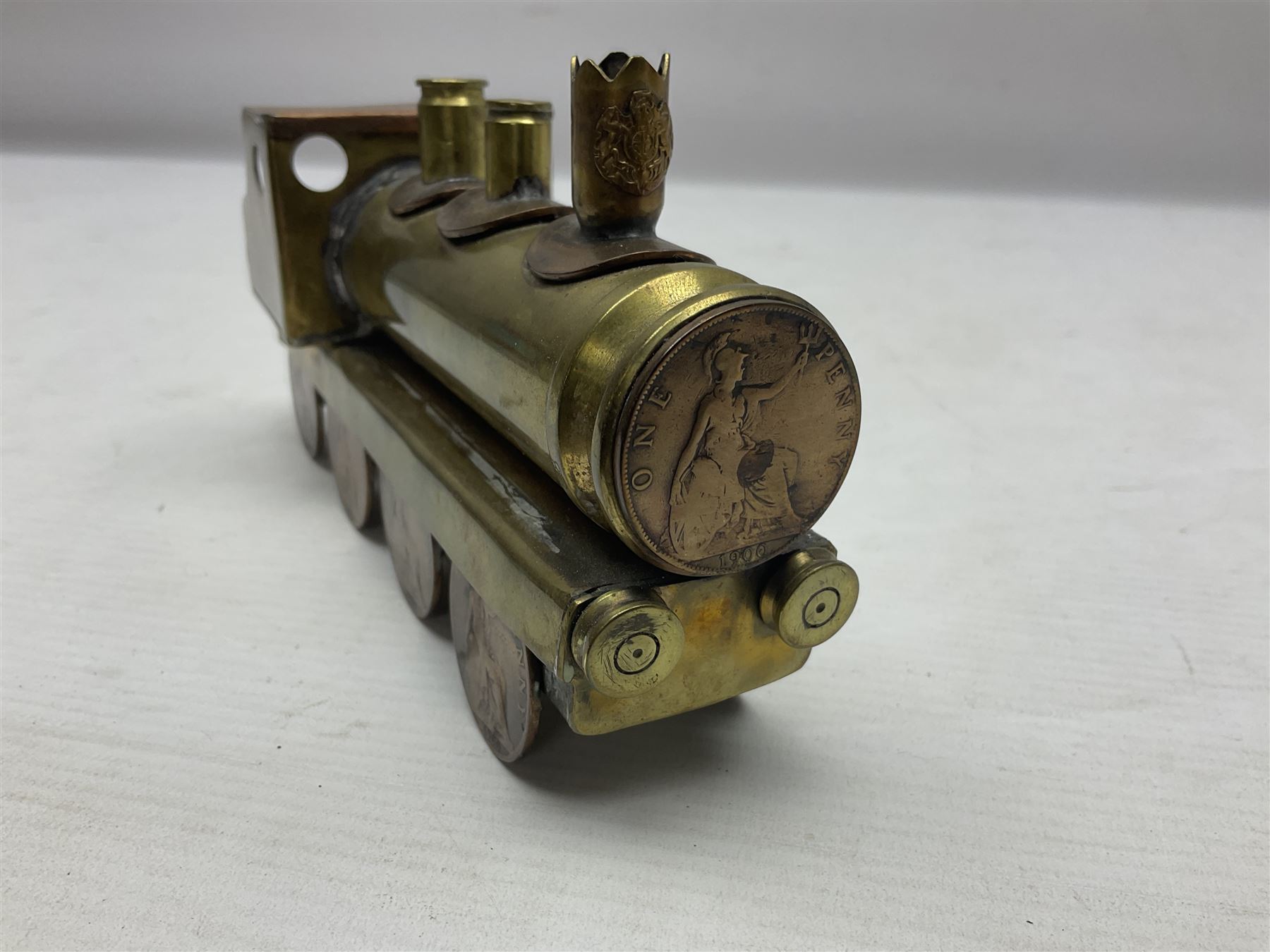 Trench Art - WWI 0-8-0 steam locomotive made from brass, copper and late Victorian pennies and half-pennies L17.5cm; WWI brass and copper tank candleholder; WWI brass shell case two-handled vase inscribed 'RFA France 1914-17'; and an unrelated brass plant holder (4)