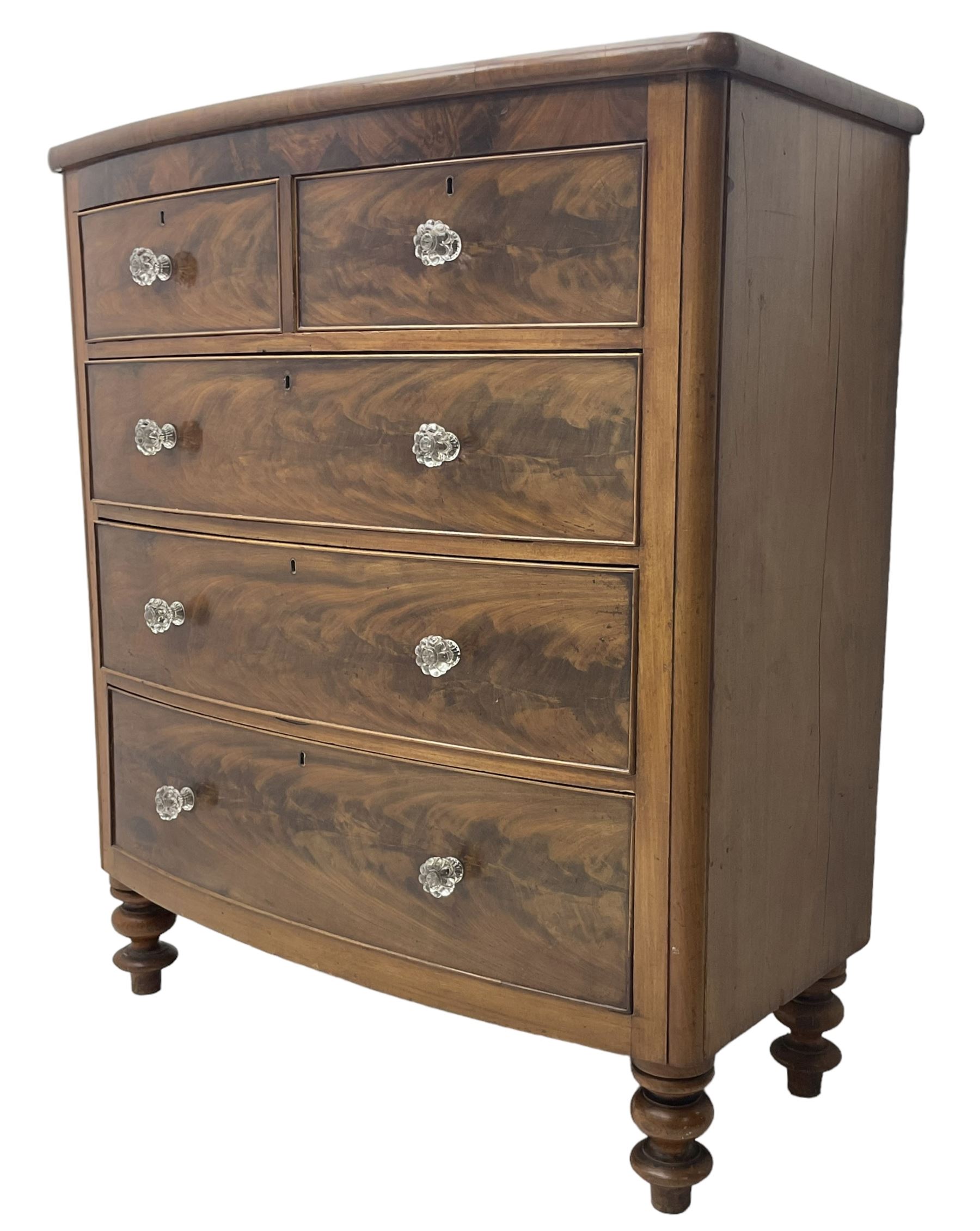 Victorian mahogany bow front chest, fitted with two short over three long graduating cock-beaded drawers, each with glass handles, raised on turned feet