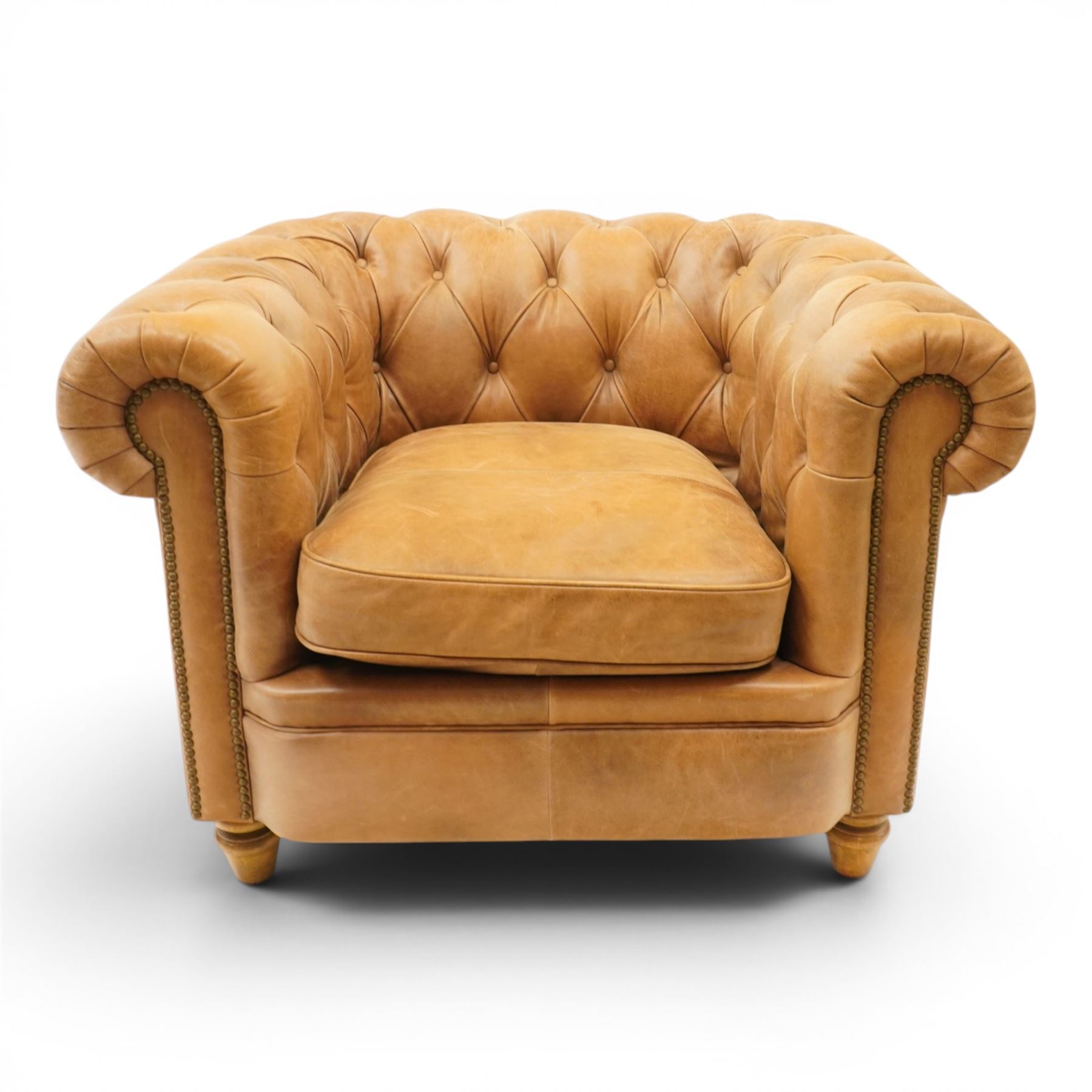 Alexander James - Chesterfield tan armchair, button backed with scrolled arms, brass studded trim raised on light wood turned feet