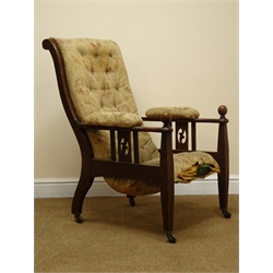  Arts & Crafts oak armchair, upholstered back, seat and arm pads, pierced and railed side panels, the square tapering supports with ball finials, brass sockets and ceramic castors  