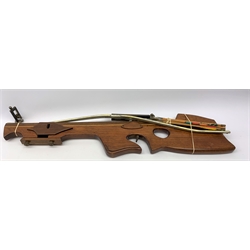 20th century crossbow with sectional mahogany shaped stock and Nikko Stirling telescopic sight L89cm; together with another similar with hinged foresight; and six arrows (8)