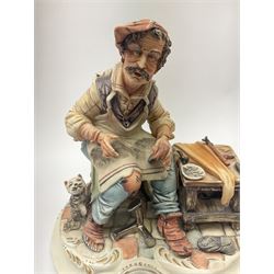 Two Capodimonte figures, the first example modelled as a shoe maker and signed Meneghetti, the second example modelled as a fisherman, with impressed mark, largest H26cm. 